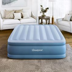 an inflatable mattress sitting on top of a living room floor