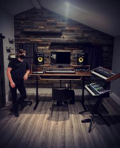 a man standing in front of a desk with sound equipment