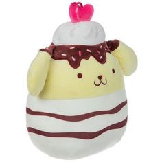 a white and brown stuffed animal with a cupcake on it's head, sitting in front of a white background