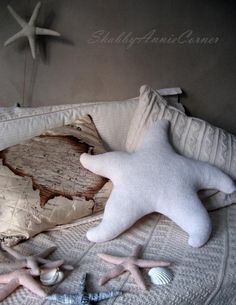 two starfishs are laying on the bed next to an old map and seashell