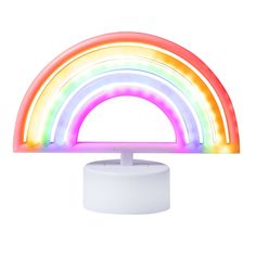 a rainbow light is on top of a white stand