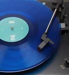 a blue record player with an old style turntable