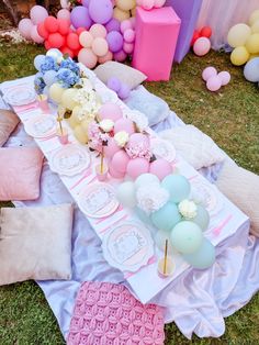 a table set up with balloons and cake