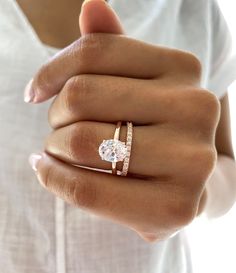 a woman's hand with a ring on it and a diamond in the middle