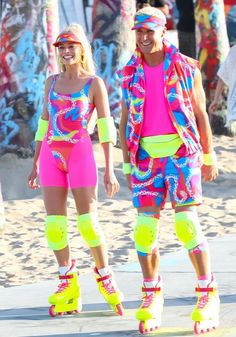 two people in colorful outfits and roller skates