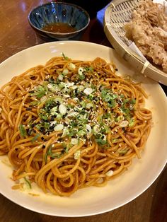 a white plate topped with spaghetti and vegetables