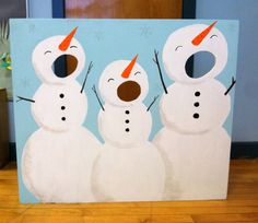 three snowmen standing next to each other in front of a blue background