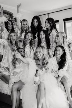 the bridesmaids are all dressed in white dresses and posing for a group photo