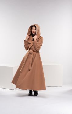 "We have stepped it up with our new winter hooded coat. It's gorgeous, inspiring, breathtaking, chic, and classic but still modern. Featuring a comfortable hood, two side pockets, and a long belt, this swing coat really captures the DNA of our brand. ◼ FIT This princess wool coat is of regular fit. To have the same look as on our model, please check our body measurements size chart below and choose the correct size for you. ◾The model in the picture is wearing size XS in Camel color. ◼ FABRIC ◾ Brown Hooded Wool Coat For Winter, Brown Hooded Wool Coat For Fall, Winter Cape Coat, Japanese Pants, Winter Cape, Hooded Winter Coat, Harem Pants Women, Maxi Coat, Coat Vintage