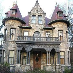 an old victorian style house with two towers