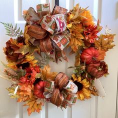 a fall wreath on a front door decorated with money bills and oranges, golds and browns