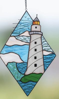 a stained glass window with a lighthouse on it