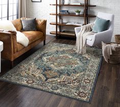 a living room filled with furniture and a rug on top of a hard wood floor