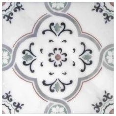 a white and black tile with an ornate design on the bottom half of its surface