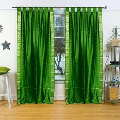 a green curtain hanging in front of a window