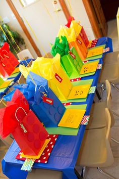 colorful bags are lined up on the table for children's lego birthday party favors