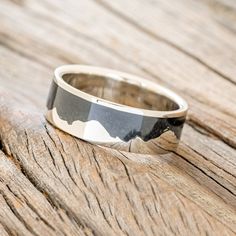 a black and white ring sitting on top of a wooden table