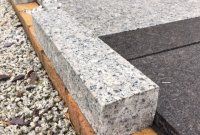 a cement bench sitting on top of a sidewalk