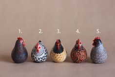 five small ceramic chickens are lined up in a row with the numbers on each side