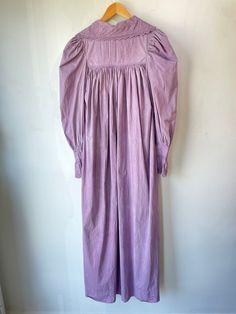 Vintage Victorian Overdyed Purple Dress. Lace-trimmed dress with bow details and puffy sleeves that make you feel like you're in a haunted 1920s mansion. The collar has black details that bring out the lacey designs. In good vintage condition with a few missing buttons (sold as is). Fits like a S/M. Feels like cotton/linen. Approx. Measurements: Underarm to underarm: 18" Length: 55" Long Sleeve Lace Trim Dress For Night, Long Sleeve Dresses With Lace Trim For Night, Elegant Cotton Dress For Night, Elegant Night Cotton Dresses, Vintage Dresses For Spring Night, Long Sleeve Victorian Dress With Lace Trim For Daywear, Vintage Night Dresses For Spring, Daywear Long Sleeve Prairie Dress With Gathered Sleeves, Daywear Prairie Dress With Gathered Sleeves