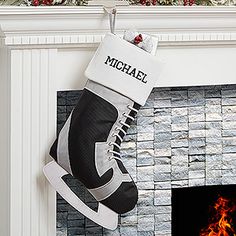 a christmas stocking hanging over a fireplace with the word michael written on it's side