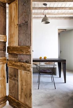 an open door leading to a dining room with a table and chairs in the background