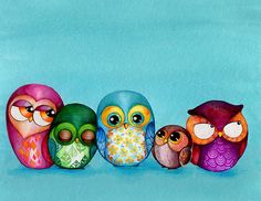 five colorful owls sitting in a row on a blue background, with one looking at the camera