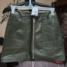 Nwt Stradivarious Faux Leather Green Mini Skirt Sz 8 Waist Is 29 Inches Length Is 16 Inches 84% Polyester /14% Cotton / 2% Viscose Fall Mini Skirt With Zip Fly, Button Down Mini Skirt, Red Mini Skirt, Green Mini Skirt, Pink Mini Skirt, Blue Mini Skirt, Skirt With Buttons, Black Pleated Skirt, Wrap Mini Skirt