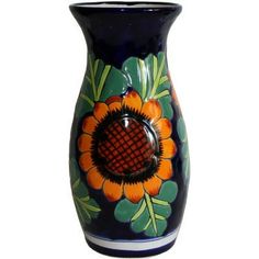 a blue vase with an orange flower painted on it