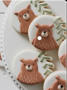 decorated cookies with bears and leaves on a plate