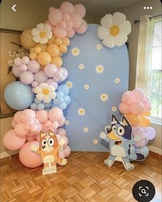 an image of balloon decorations in the shape of animals and flowers on wooden flooring