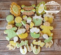 baby shower cookies are arranged on a wooden table