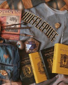 some harry potter books and other items on a bed