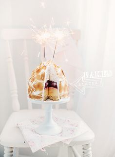 a cake on a table with sparklers in the air and an instagram post about it