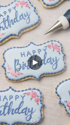 decorated cookies with the words happy birthday written in blue frosting and pink roses on them