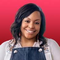 a woman wearing overalls and smiling at the camera