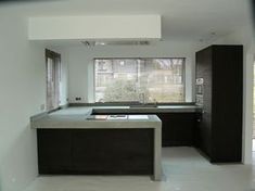 an empty kitchen is seen through a window