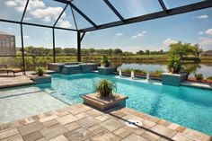 an outdoor swimming pool surrounded by patio furniture