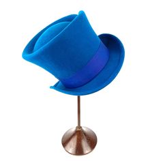 Add a touch of magical charm to your outfit with our Mad Hatter Felt Top Hat! Inspired by the beloved characters from Alice in Wonderland. This hat is crafted from high-quality felt that's both durable and soft to the touch. The shape and the color felt on the hat will instantly transport you to the magical world of Wonderland.  Perfect for costume parties, themed events, or even as a statement accessory, this Mad Hatter Felt Top Hat is sure to turn heads and make you the center of attention wherever you go. So embrace your inner Mad Hatter and stand out from the crowd with this enchanting hat! Measurements in centimeters are 31 x 25. Crown height 15. Brim length 5.5. These measurements may have some slight variation depending on the size of the hat. All our felt hats have a 100% natural r Adjustable Wide Brim Costume Hats For Themed Events, Adjustable Costume Hats For Themed Events, Fitted Mini Hats For Themed Events, Novelty Costume Hat With Curved Brim, Adjustable Brimmed Felt Costume Hat, Adjustable Brimmed Felt Hat For Costume, Fitted Brimmed Hat For Themed Events, Adjustable Flat Brim Costume Hat, Themed Adjustable Costume Hats