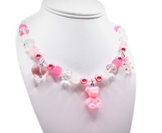 These are handmade, hand crafted beaded necklace with diamond beads and pink and white pearls, with three cute little charms attached with the necklace . These necklaces are for all ages, weather your a child who loves to play and be fashionable and have fun or a adult who loves cute and fun things! This fashion accessory will bring joy to you, especially for gifts !  These jewelry is locally made in Austin TX if you have any questions please feel free to contact us at our message board .  Fragi Cheap Playful Pink Charm Necklaces, Cheap Pink Charm Necklaces, Affordable Playful Pink Charm Necklaces, Cheap Pink Charm Necklaces With Heart Beads, Cheap Personalized Pink Beaded Necklaces, Pink Birthday Charm Necklace, Cheap Pink Necklaces With Pearl Charm, Cheap Fun Pink Charm Necklace, Cheap Customized Pink Necklaces