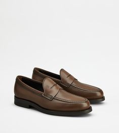 Timeless Brown Semi-formal Moccasins, Timeless Brown Moc Toe Moccasins, Timeless Brown Moccasins With Stitched Sole, Brown Calf Leather Moccasins With Brogue Detailing, Timeless Brown Moccasins With Leather Lining, Timeless Brown Loafers With Leather Footbed, Semi-formal Brown Moccasins With Leather Footbed, Classic Brown Dress Shoes With Stitched Sole, Timeless Brown Moccasins For Business