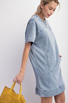 Details Brand: Easel Denim Tunic Dress Mineral Wash Panel Detailing Rounded Neckline Slightly Dropped Shoulders Short Sleeves Front Pockets Snap Back Button Closure Material and Care 97% Cotton 3% Spandex Hand Wash Cold Hang or Line Dry Measurements of Garment Bust of the garment is measured armpit to armpit and then doubled. Length of the garment is measured from the top of the shoulder to the bottom of the hem line. Sleeve Length of the garment is measured from the top part of the shoulder sea Casual Medium Wash Dress With Pockets, Casual Medium Wash Denim Dress With Pockets, Trendy Washed Dress With Relaxed Fit, Trendy Relaxed Fit Washed Dress, Knee-length Washed Denim Blue Dress, Casual Short Sleeve Denim Blue Mini Dress, Casual Knee-length Denim Dress With Pockets, Casual Washed Blue Denim Dress With Pockets, Casual Light Wash Denim Dress With Pockets