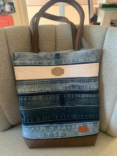 a blue and white striped bag sitting on top of a couch