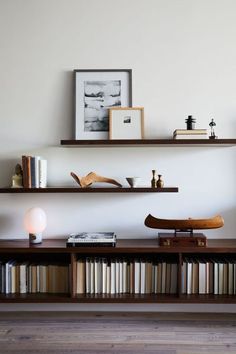 two shelves with books and other items on them