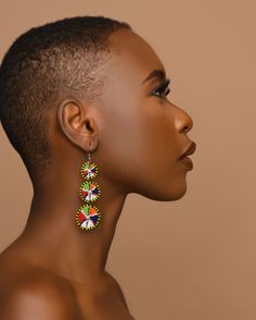 Add a pop of colour and culture to your jewellery collection with these stunning beaded earrings. Handcrafted with intricate beadwork, these earrings feature a vibrant multicoloured design. The dangle/drop style adds a touch of elegance and movement to any outfit, making them perfect for both casual and formal occasions. These earrings are for anyone who loves unique and ethically made jewellery.  Length :7cm Width :2cm Weight:10g Material: Beads Colorful Traditional Earrings With Dangling Beads, Multicolor Large Beads Drop Earrings, Traditional Colorful Earrings With Dangling Beads, Traditional Multicolor Earrings With Large Beads, Traditional Multicolor Chandelier Earrings With Colorful Beads, Traditional Multicolor Beaded Chandelier Earrings, Colorful Traditional Earrings, Multicolor Beaded Chandelier Earrings, Beaded Multicolor Chandelier Earrings