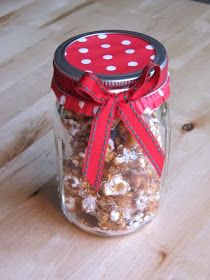 a glass jar filled with nuts on top of a wooden table