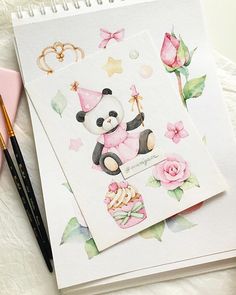 a drawing of a panda bear with pink flowers on it's side and a notepad next to it