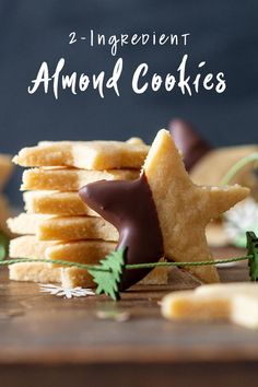 two ingredient almond cookies stacked on top of each other with chocolate and sprigs