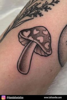 a mushroom with hearts on it is shown in black and white tattoo art work by tattovolo