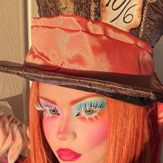 a close up of a doll wearing a hat